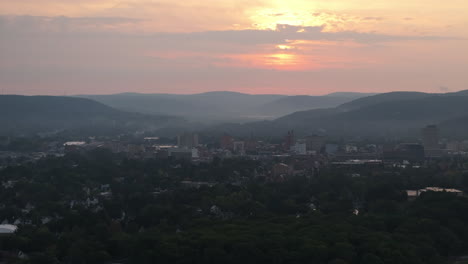 drone shot of binghamton, new york at sunrise. shot during the summer.