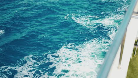 View-of-the-Mediterranean-Sea-from-the-railing-of-a-cruise-ship,-witnessing-the-ship-breaking-through-the-waves