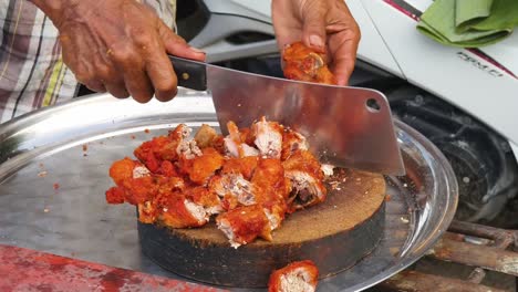 street vendor preparing and selling fried chicken