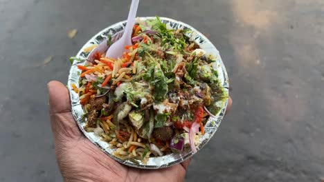 veg biryani served on disposable plate by a roadside stall.