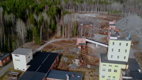 Drone-shot-tilting-up-over-some-old-mining-facility-in-Sweden