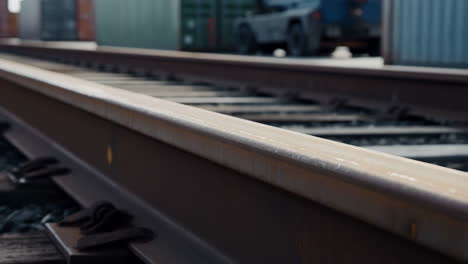 close-up of train tracks with an industrial background