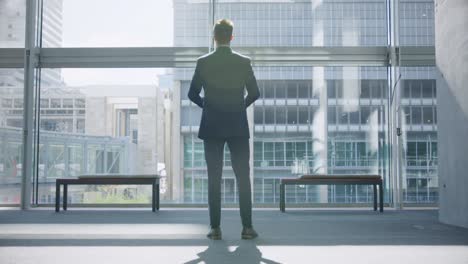 businessman looking upwards in the lobby at office 4k