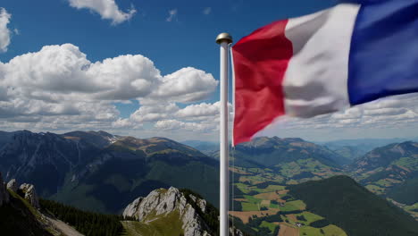 french flag on a mountaintop with panoramic view