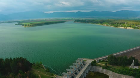 aerial view of the blue koprinka dam with some cloudy weather during the summer