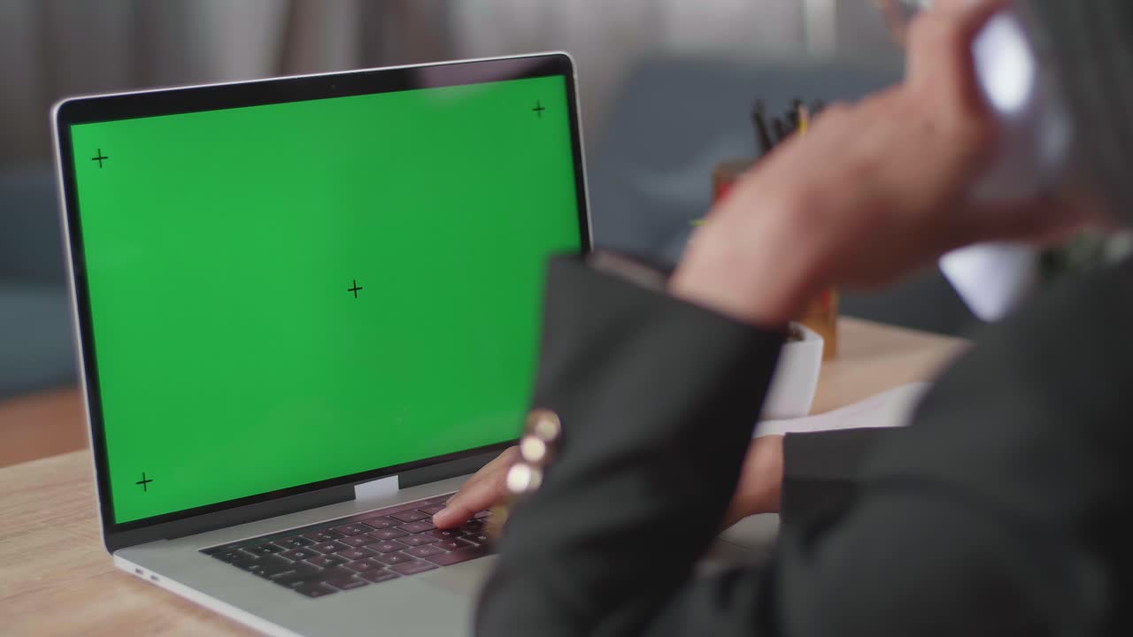 mujer trabajando en una computadora portátil con pantalla verde