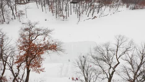 aerial, family and friends skating on outdoor homemade ice rink on frozen lake