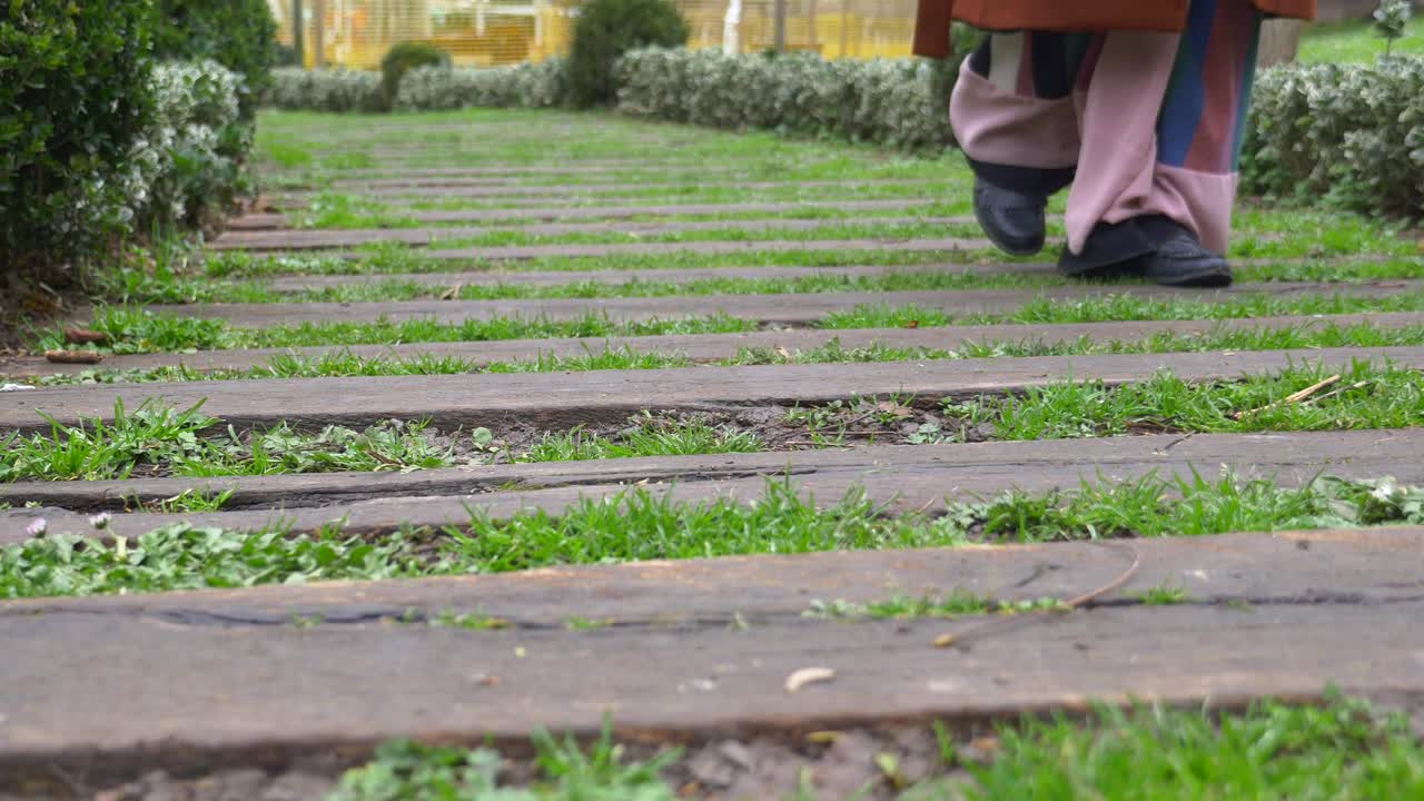 Person Walking on a Grass Path