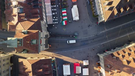 Birdview droneshot of the marketplace (Waisenhausplatz and Bärenplatz) in front of the Käfigtower in Bern during a carneval