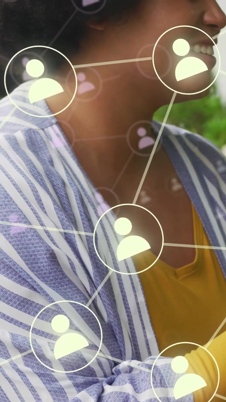 Mid adult woman turning head smiling, user icons emerging, layering over her, connecting for tech