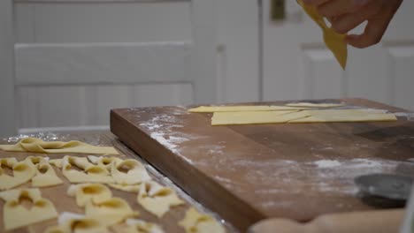 flattened dough with slits being twisted to create ribbon-shaped angel wings