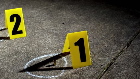 overhead view scanning bullets shells with evidence markers at night