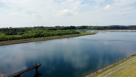 North-West-water-supply-reservoir-aerial-view-circling-across-rural-countryside-lake