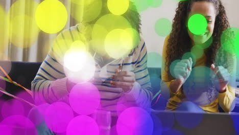 colorful bokeh light animation over people enjoying time together indoors