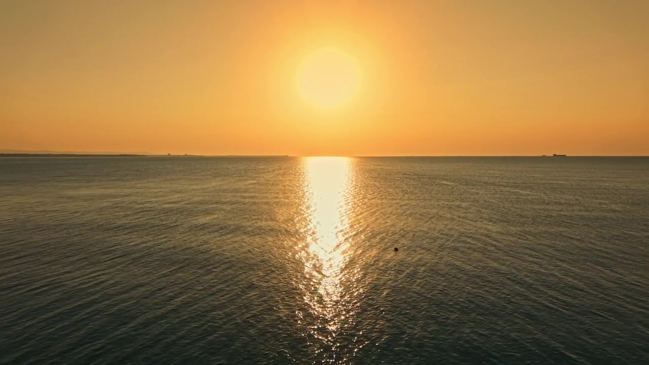 Sunset over the ocean with light reflecting on water and a clear sky during evening hours