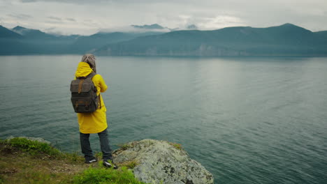 woman hiking by a misty lake