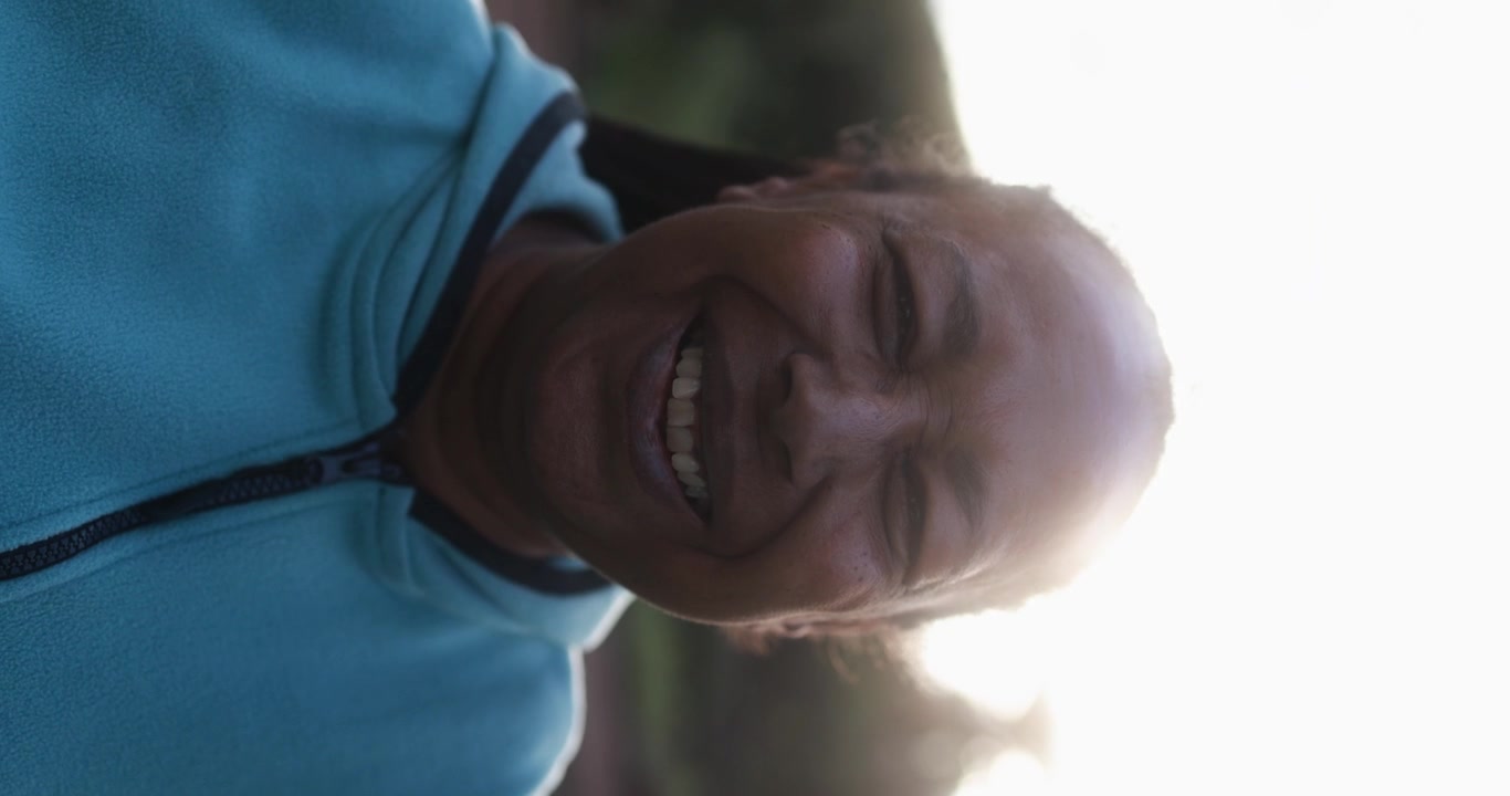 Happy Senior Black Woman Laughing Outdoors in Sunlight
