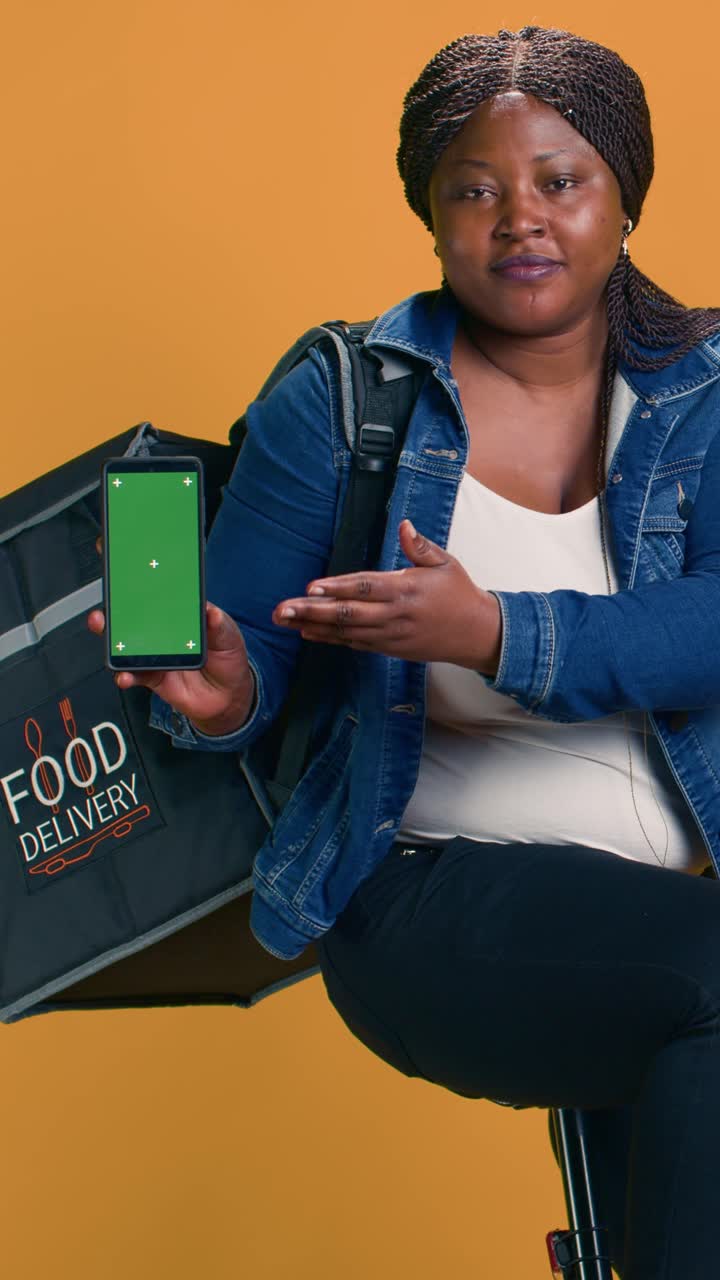 Food delivery woman showing mobile app