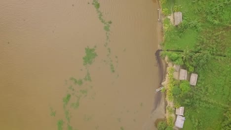 Aerial-view-of-the-Orinoco-River-shore,-with-indigenous-houses-on-it