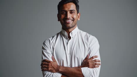 smiling man in white shirt with arms crossed
