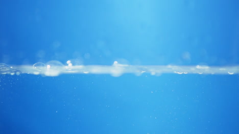 a crystal-clear drop of water drips gracefully in slow motion, capturing the essence of purity, health, and clean living.