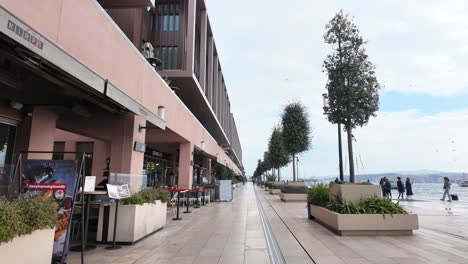 urban waterfront promenade with restaurants and shops