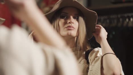 woman trying on a hat in a store