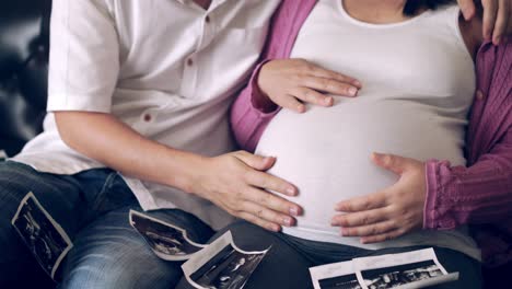 pregnant couple feels love and relax at home.