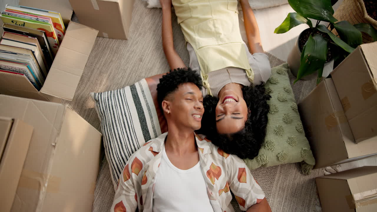 Couple Lying on Floor Surrounded by Moving Boxes