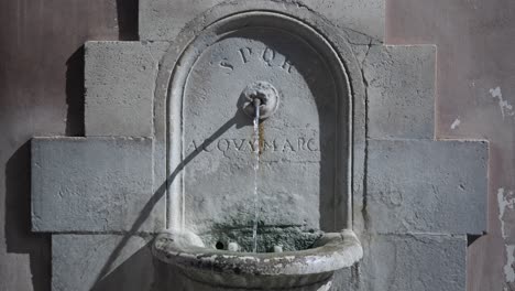 antique public drinking fountain in the downtown of rome, italy