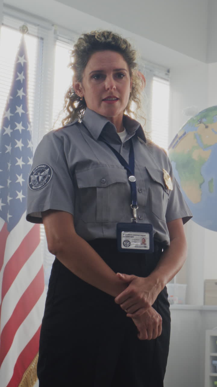 American Female TSA Security Officer Explaining Safety Rules to Young Students at Elementary School