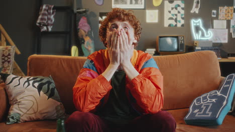 Upset Sports Fan Emotionally Reacting to Disappointing Loss during TV Game