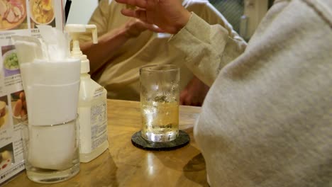 close-up of people drinking alcohol in a japanese bar in tokyo, japan in slow motion