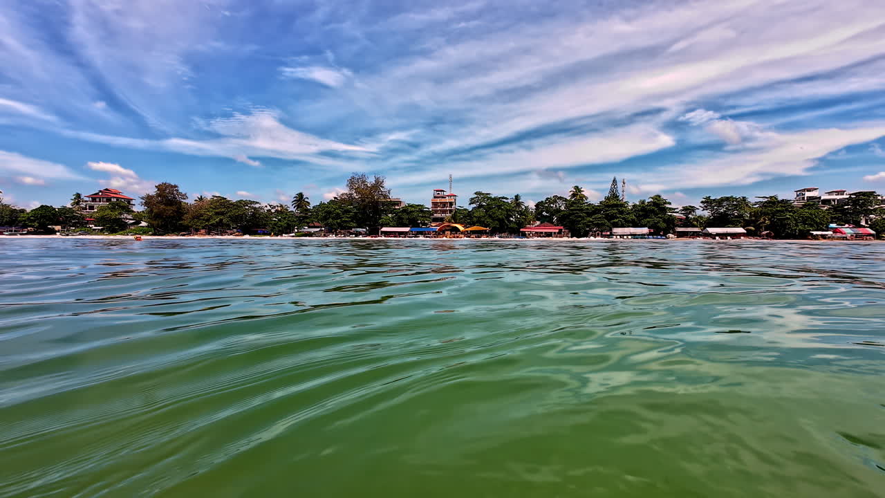 Serene beach view with calm waves and blue sky on a sunny day