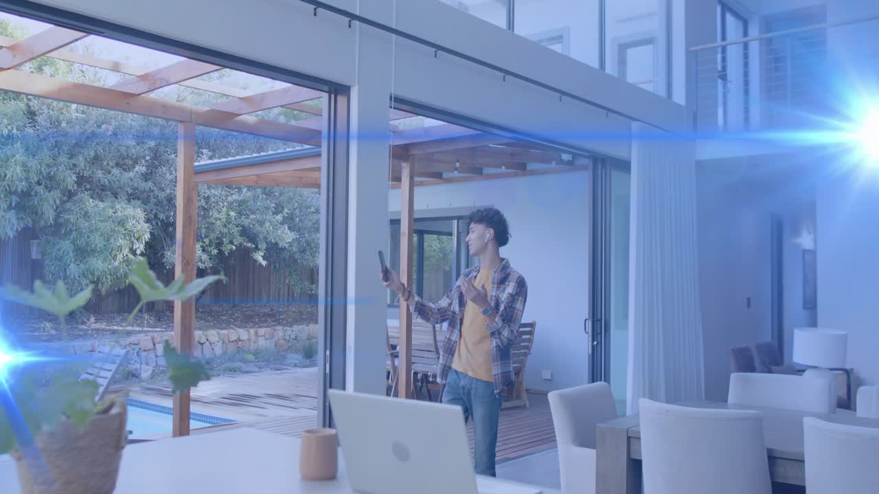 Man holding phone by sliding glass door, raising and swiping while blue flare causing tech test