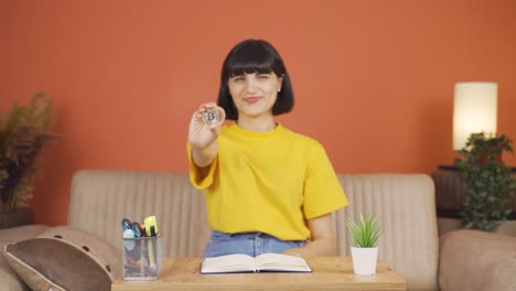 Woman-holding-bitcoin-and-showing-it.