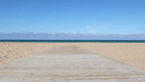 tracking shot on wooden footway in the beach