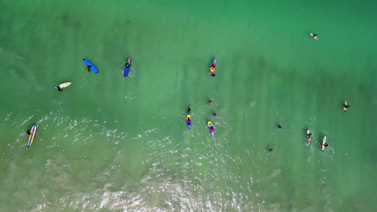 People on surfboards at waters of Lombok's Selong Belanak Beach, a tropical haven on the Indonesian island