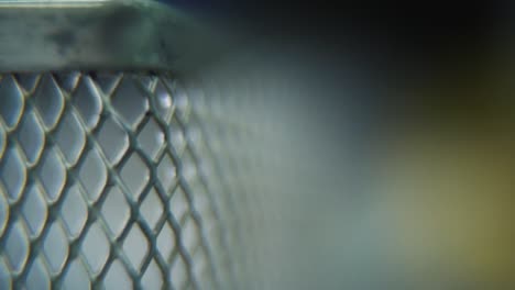 a hyper macro shot of a metal grid, steel pattern, iron industrial texture, aluminum material, super slow motion, full hd 120 fps, pan left smooth movement