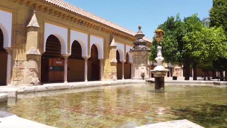 mezquita mosque cathedral in cordoba, andalusia, spain - pan shot of the fountain and courtyard