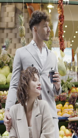 couple enjoying coffee at a market