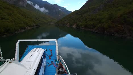 serenity on koman lake in albania, a peaceful journey with a ferry through stunning alpine mountains and tranquil waters