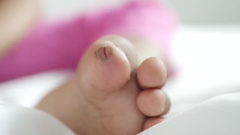 close up of 5 years old child dry feet on bed