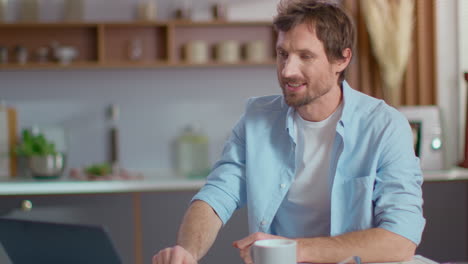 man having video call on laptop