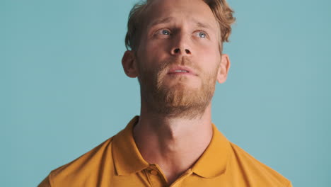 Handsome-man-trying-to-remember-in-studio