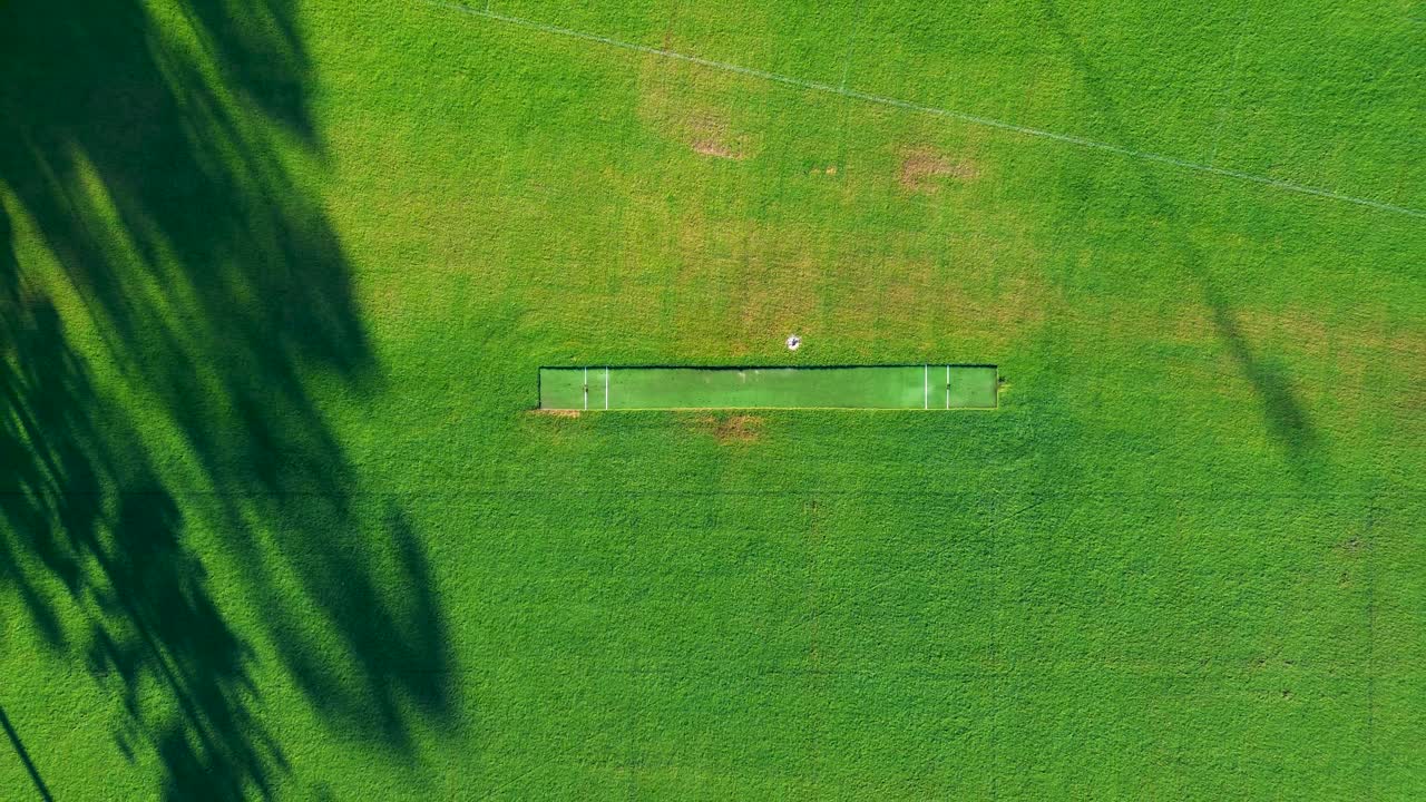 Drone aerial landscape of local public cricket pitch on grassy lawn on sports field oval arena grounds in rural town suburbs of Central Coast Australia leisure fitness community outdoors games contest