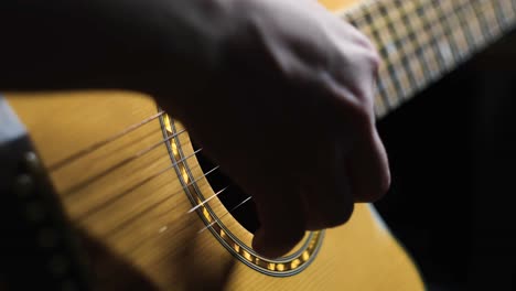 person playing an acoustic guitar