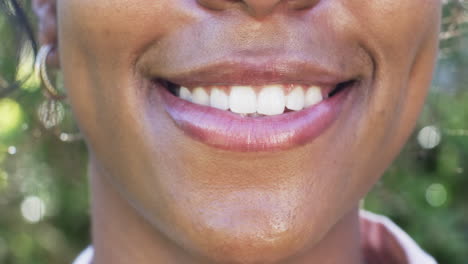 a close-up of an african american woman''s smile reveals gleaming white teeth