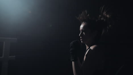 female boxer training in a dark gym