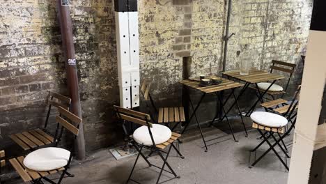 laneway empty cafe sydney nsw australia rustic alfresco tables along alley wall